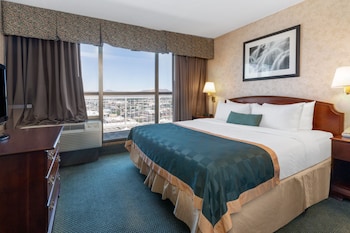 A spacious lobby with a reception desk, comfortable seating, and decorative plants.