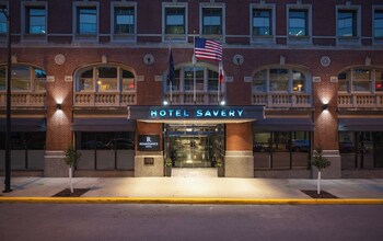 A hotel facade with a prominent sign reading "SAVERY HOTEL" and "Renaissance Hotel."