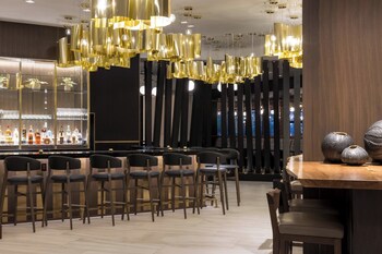 Enjoy a meal under the stars at Fall Line Kitchen & Bar's outdoor seating area, surrounded by lush greenery and twinkling lights.