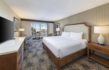 The Redondo Hotel with a modern architectural design, featuring a prominent entrance and a landscaped area with palm trees.