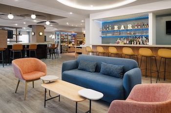 A modern retail space with shelves stocked with snacks, a refrigerated display, and a central table with packaged goods.