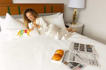 Premium bedding, desk, laptop workspace, blackout drapes