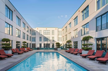 Relax by the pool surrounded by lush greenery and enjoy the hotel's contemporary design.