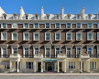 A row of townhouses with a prominent 'LONDON MARBLE ARCH' sign, uniform window designs, and a symmetrical facade.