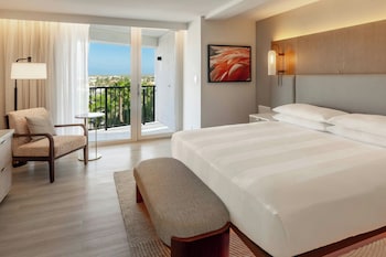 On the beach, white sand, beach cabanas, sun loungers