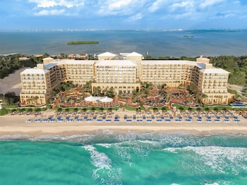 On the beach, white sand, beach cabanas, sun loungers