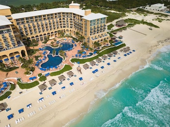 On the beach, white sand, beach cabanas, sun loungers