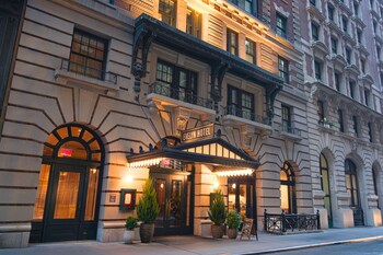 The Evelyn Hotel with a classic facade, large windows, and a prominent entrance.