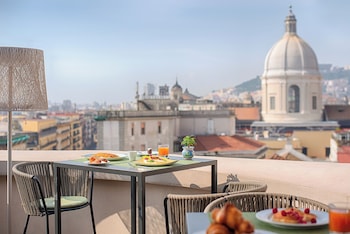 A multi-story hotel with a classic architectural style, featuring balconies and a prominent entrance.