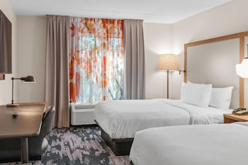 Relax in a spacious room with a sofa, armchairs, and dining table near a large window.