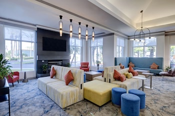 A spacious lobby with a high ceiling, modern lighting fixtures, and a central reception area.