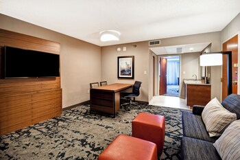 A multi-level atrium with modern furnishings, including seating areas and a central walkway.