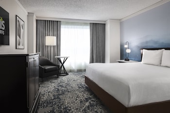 Enjoy a meal with a city view from the dining area, featuring large windows and a warm ambiance.