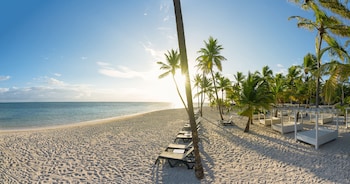 Playa privada, playa de arena blanca, camastros y sombrillas