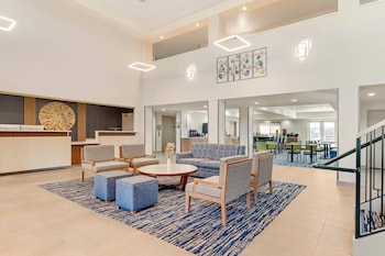 Welcome to our hotel lobby, featuring a reception desk, seating area, and decorative wall piece.
