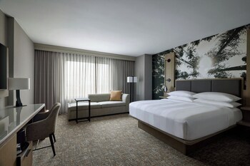 A spacious lobby with a fireplace, comfortable seating, and large windows.