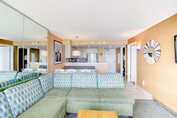 A modern kitchen with granite countertops, stainless steel appliances, and light-colored cabinetry.