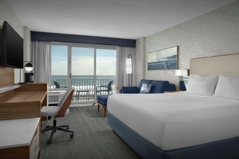 A coastal hotel with a boardwalk, beach access, and a gazebo.