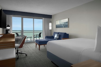A coastal hotel with a boardwalk, beach access, and a gazebo.