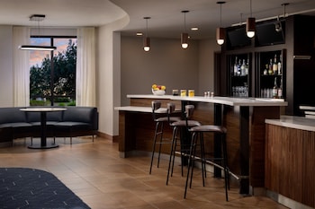 Relax in the outdoor seating area with a fire feature, surrounded by comfortable chairs and tables.