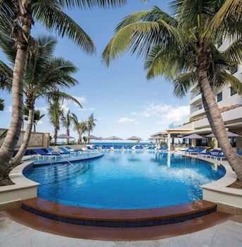 On the beach, white sand, beach cabanas, sun loungers