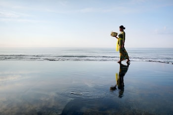 On the beach, black sand, sun-loungers, beach umbrellas