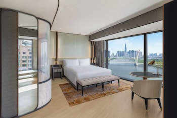 A high-rise bar with a city view, large windows, and modern furnishings.