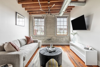 Luxury Suite, 3 Bedrooms, 2 Bathrooms | Living room | 50-inch Smart TV with digital channels, books, pay movies