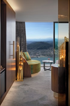Enjoy breathtaking views of the surrounding mountains from this stylish room with a curved seating area and large window.