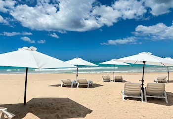 Beach nearby, white sand, sun loungers, beach umbrellas