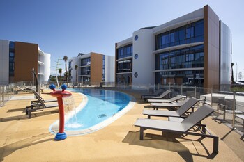 Seasonal outdoor pool, open 10:00 AM to 6:00 PM, pool loungers