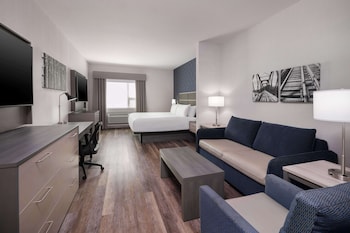 Premium bedding, desk, laptop workspace, blackout drapes