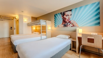 Premium bedding, desk, laptop workspace, blackout drapes