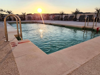 Seasonal outdoor pool, open 11:00 AM to 9:00 PM, sun loungers
