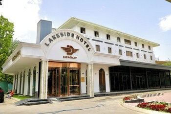 A spacious lobby with a checkered floor, seating areas, and a reception desk.
