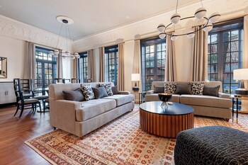 3BR Group Haven + Private Patio Walk to French Qtr | The Mayfair | Living area | 65-inch Smart TV with cable channels, Netflix, Hulu