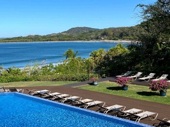 Outdoor pool, open 7:00 AM to 10:00 PM, pool loungers