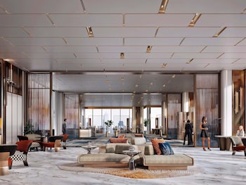 A modern restaurant interior with a city view, wooden flooring, and a variety of seating arrangements.