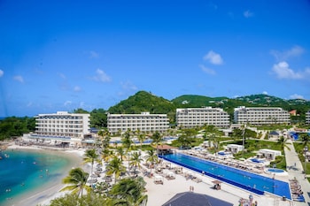 On the beach, white sand, sun loungers, beach towels
