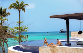 On the beach, white sand, sun loungers, beach towels
