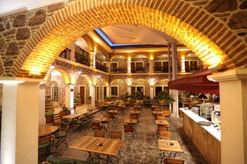 Enjoy meals in this elegant dining area with high ceilings and stone arches.