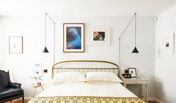 En takterrass med en soffa och krukväxter, med utsikt över stadsbilden.