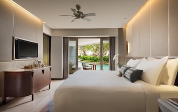 Un resort con varias piscinas, palmeras y edificios del complejo.