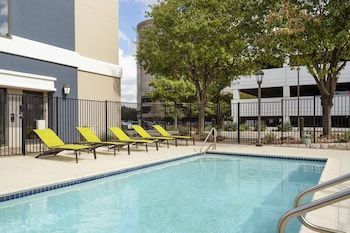 Welcome to Springhill Suites, featuring a contemporary design with a central entrance and evenly spaced windows.