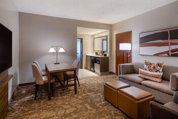 A hotel lobby with multiple floors, seating areas, and a restaurant named 'Cyprus Grille'.