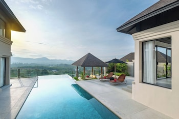 Relax by the rectangular pool surrounded by a spacious deck and shaded by a gazebo.
