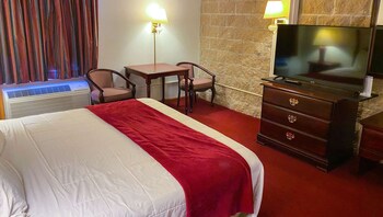 A reception desk with a sign reading "Welcome to Voyageur Inn & Conference Center".