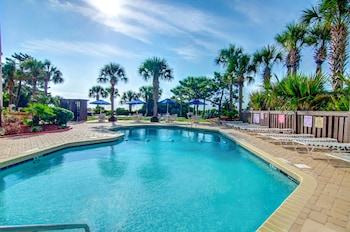Stroll along the beachside promenade with a clear view of the ocean.