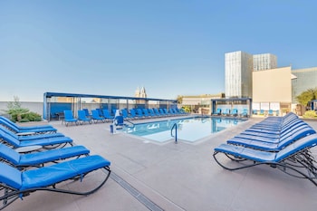 Seasonal outdoor pool, open 8:00 AM to 10:00 PM, pool umbrellas