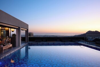 Seasonal outdoor pool, open 10:00 AM to 7:30 PM, pool umbrellas